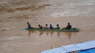 Sechs Erwachsene und ein Kind auf einem Boot auf dem Nam Ou